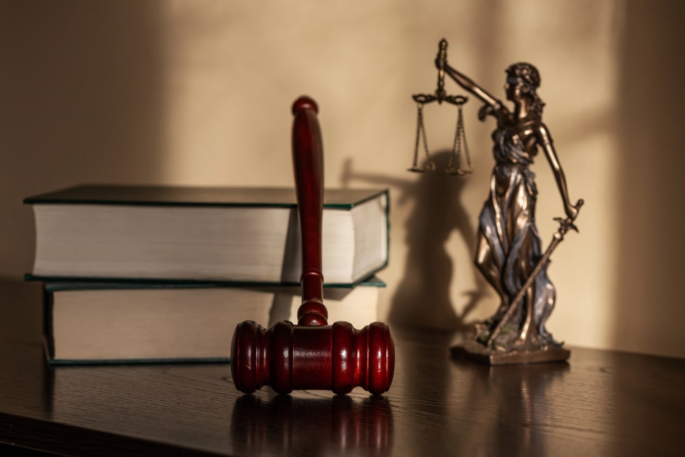 Lady Justice statue, law books, and judge’s gavel on desk, symbolizing personal injury law in Belleville NJ