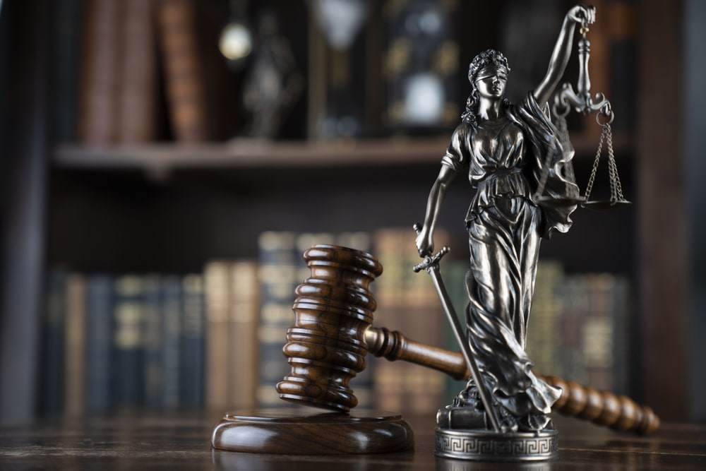 Lady Justice and judge’s gavel on desk with law books, symbolizing personal injury legal advocacy in Linden NJ.