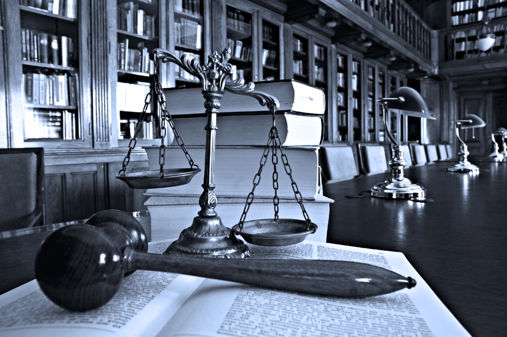 Scales of justice, gavel, and law books in library setting, representing personal injury law in Nutley NJ.