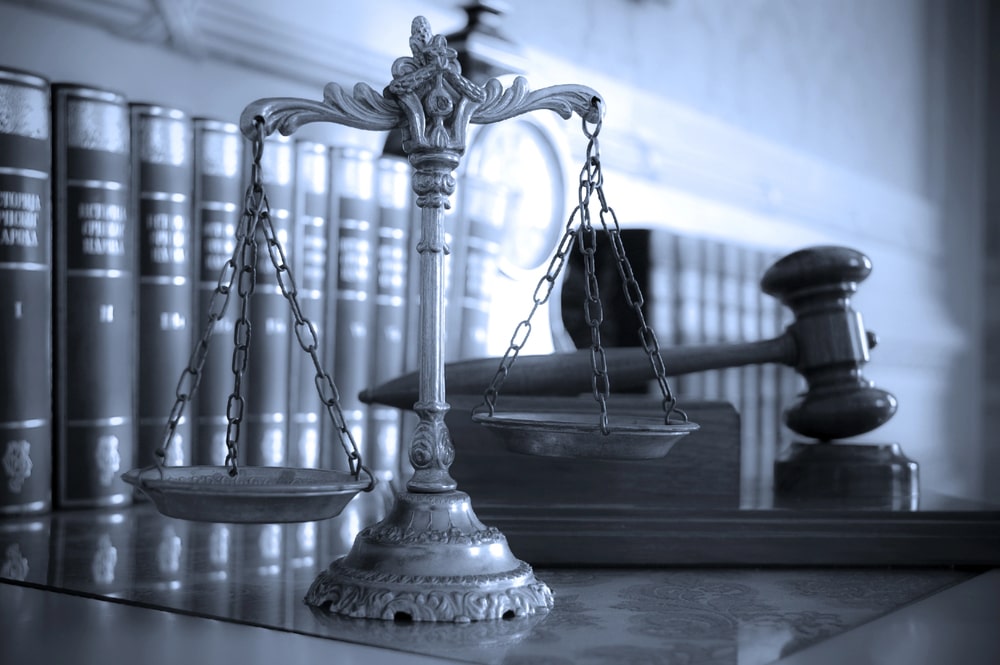 Scales of justice and judge’s gavel with law books in background, symbolizing personal injury law in South Plainfield NJ.