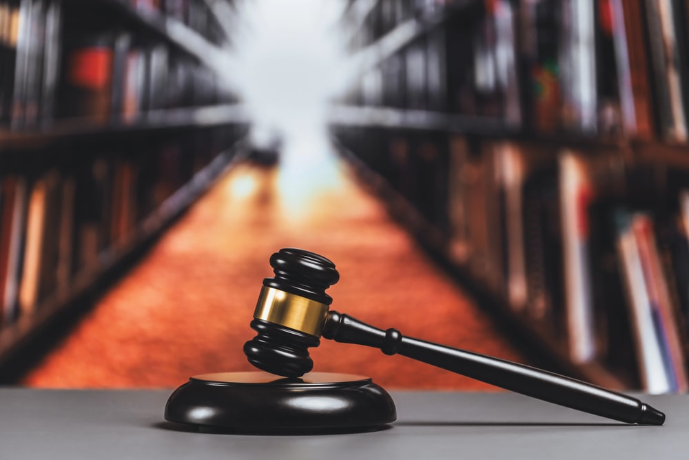 Judge’s gavel on desk in front of blurred law library shelves, symbolizing personal injury law in West Orange NJ.